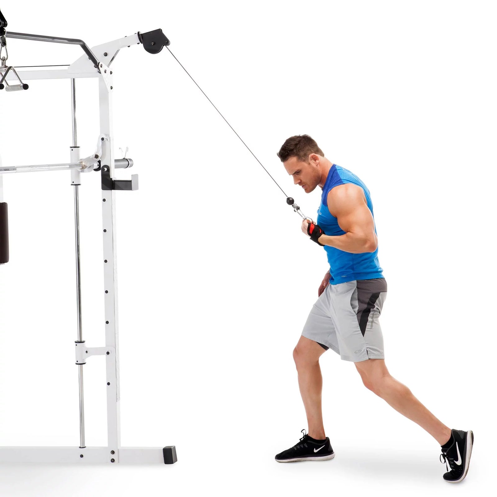 Compact home gym system with multiple strength training stations.